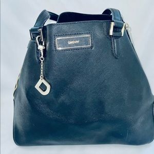 DKNY large faux black leather triangular “Side-zipper”  large purse Pre-Owned